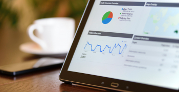 analytics dashboard viewed on a tablet sitting on a table